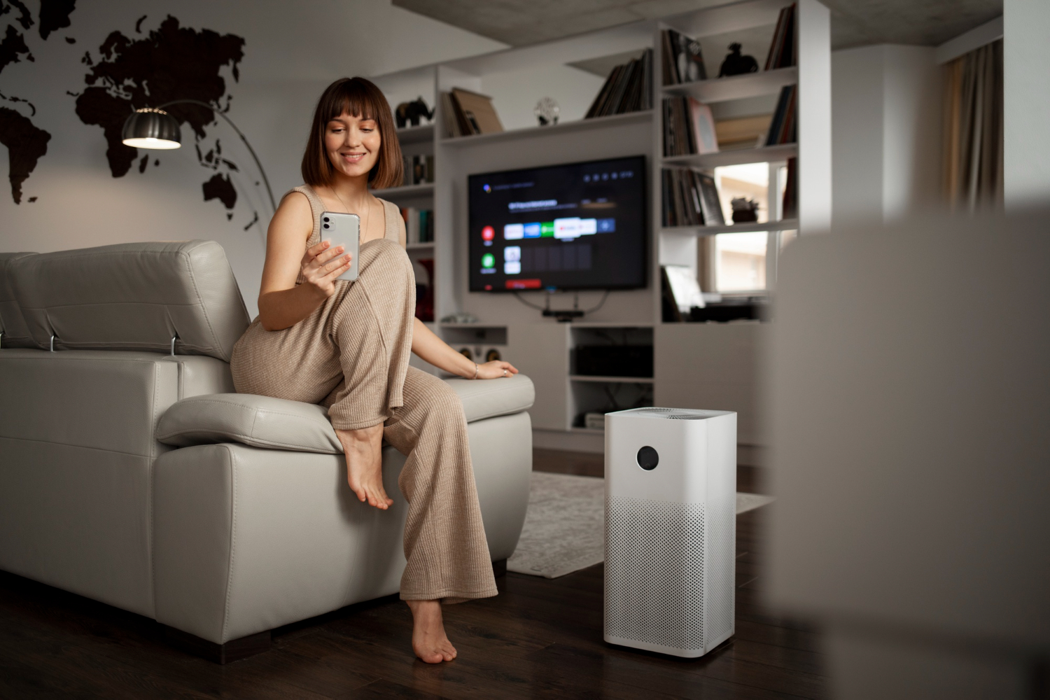 woman using air purifier at home